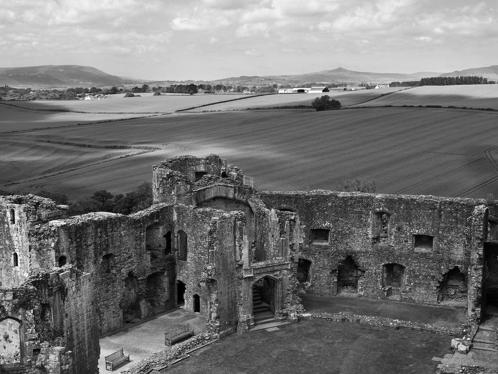 Image of Raglan Castle. blackandwhite bw castle monochrome wales landscape ruin medieval cornfields raglan raglancastle monmouthshire castlecourtyard cloudshadows wiremoons