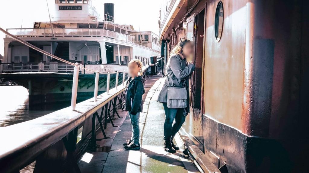 Hercules の画像. vintage style mother daughter girls women curious confident explore boats tug historic maritime water light dark highlight two portrait natural san francisco california