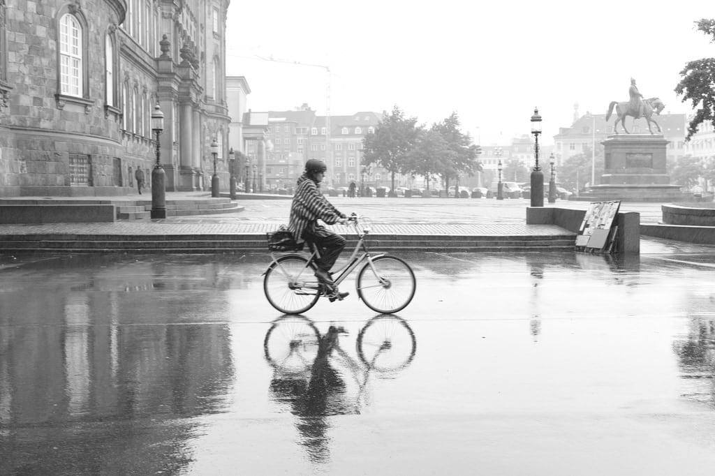 Image of Frederik VII. leica people woman wet bicycle reflections denmark christiansborg wetreflection bicyclerider aposummicronm aposummicronm50mmasph 50mmf20asph
