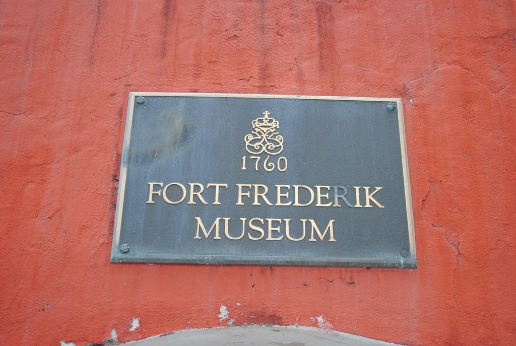 Image of Fort Frederik. red sign museum fort stcroix historicplace usvi historiclandmark 1760 saintcroix fortfrederikstcroix fortfrederikplaque untiedstatesvirginislands
